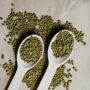 green beans on white wooden spoons
