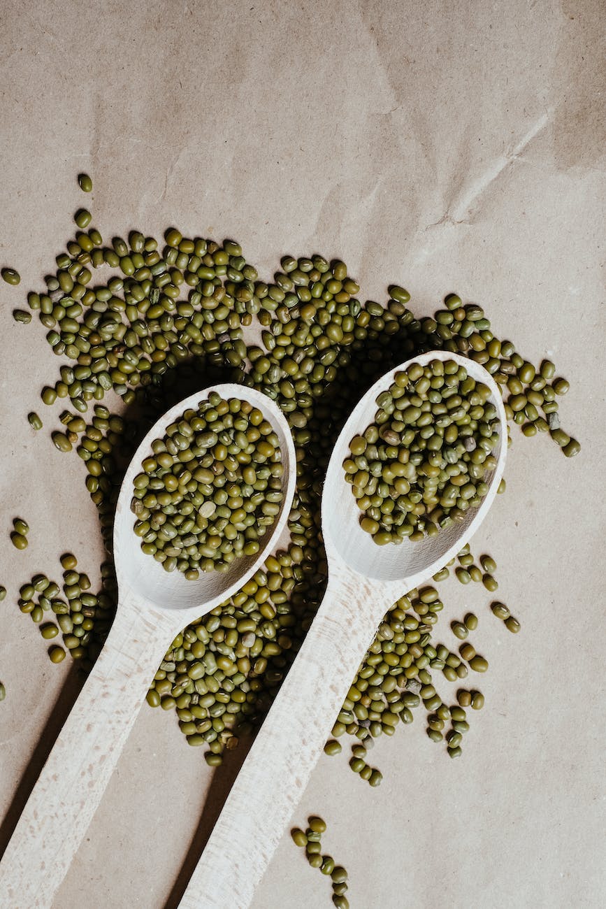 green beans on white wooden spoons